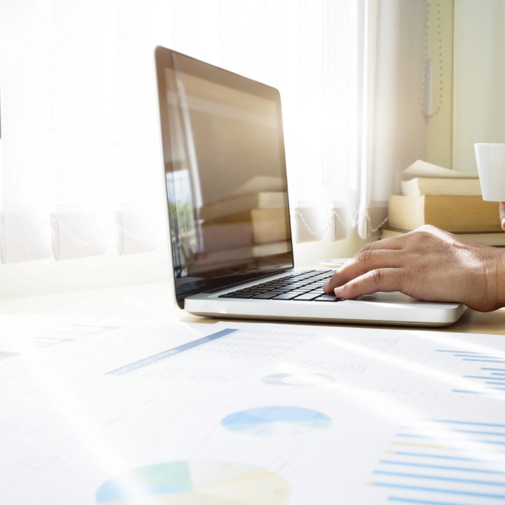 Business graph information diagram and business man using computer laptop to workaing on desk as concept in morning light.